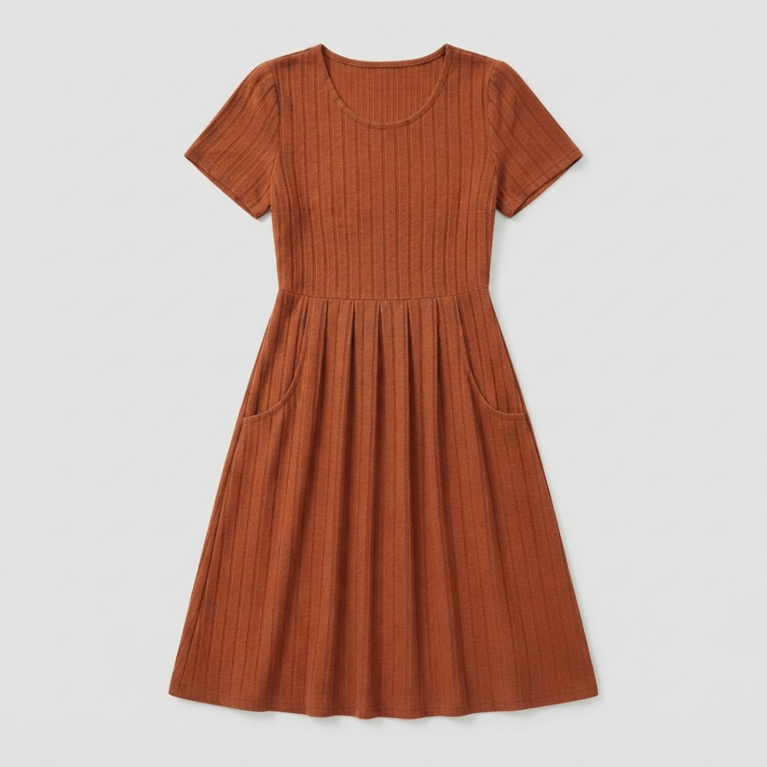 A rust-orange short-sleeve ribbed knit dress with a gathered waist and side pockets, shown flat on a light gray background.