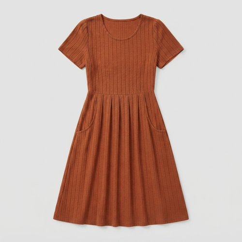 A rust-orange short-sleeve ribbed knit dress with a gathered waist and side pockets, shown flat on a light gray background.