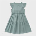 A dusty sage green tiered dress for toddlers, featuring ruffled cap sleeves, a round neckline, and gathered seams at the waist and hips, shown against a light gray background.