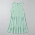 A sleeveless, tiered mini dress in a light mint green color with a textured crinkle fabric, shown flat against a light gray background.