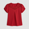 A red short-sleeve blouse with a scoop neckline, featuring a decorative red lace yoke panel and puffed sleeves, shown against a light gray background.