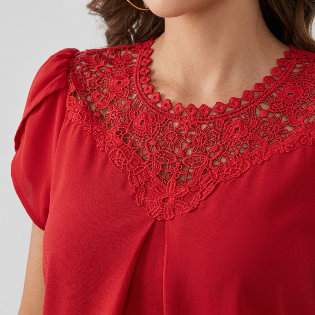 A close-up of a woman wearing a bright red blouse with short puff sleeves and a detailed red lace yoke around the neckline.