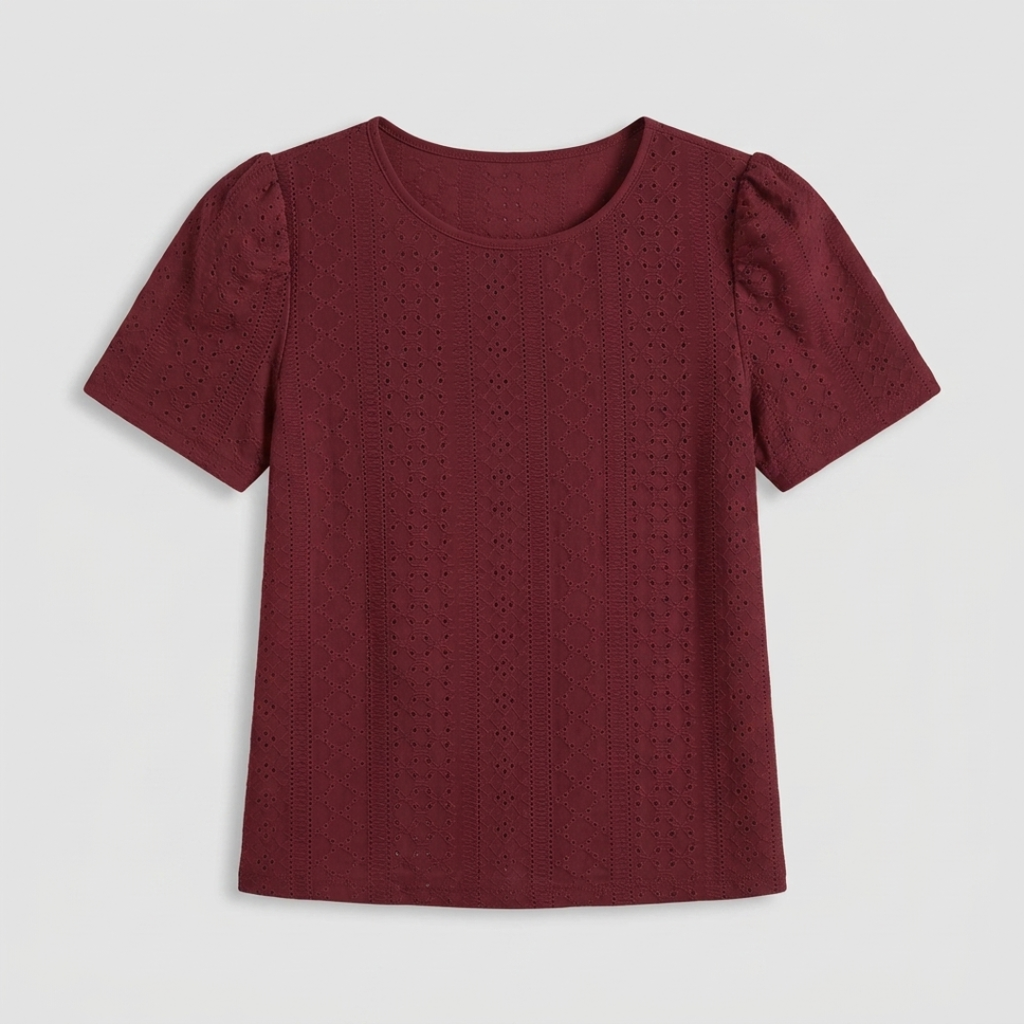 A short-sleeve crewneck top in deep burgundy, featuring a textured eyelet fabric and puffed sleeves, shown flat against a light gray background.
