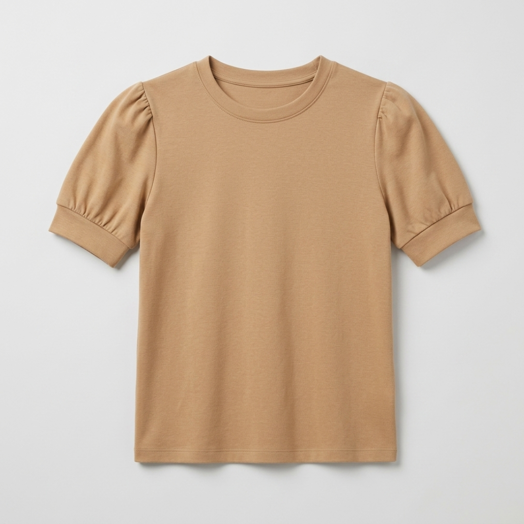 A short-sleeve crewneck t-shirt in a warm camel tan color, featuring puffed sleeves with cuffed edges, shown flat against a light gray background.
